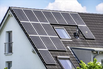 Solar roof, solar panels on a pitched roof of a residential building, renewable energy generation