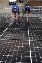 Installation of solar modules on the roof of a barn on a farm, over 240 photovoltaic modules are