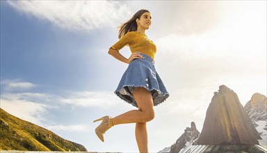 Woman walking in the mountains in sunny weather wearing a blue denim skirt and a yellow top, AI