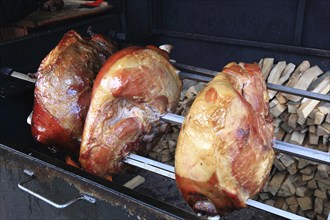 Pork knuckles are grilled on a spit over a wood fire, a speciality in Prague, Czech Republic,