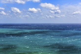 View of turquoise sea, horizon, coastline at La Isleta, sunny weather, typical light mood,