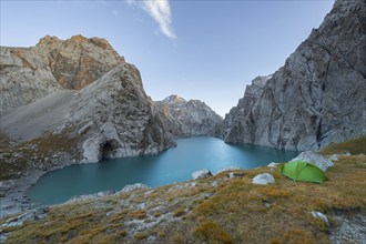 Wild camping, camping in the wilderness with a tent in front of mountain lake Kol Suu, Sary Beles