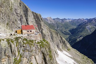 Aerial view of mountain hut Cabane de l'A Neuve, located on a steep rock formation, near La Fouly,