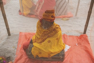 Devotees offer prayers at a tent city on the eve of consecration ceremony of the Ram temple, in