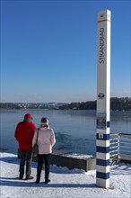 Winter in the Ruhr area, Lake Baldeney, snow-covered, partly frozen lake, shore, pier Strandbad,