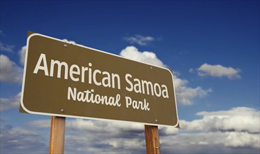 American Samoa national park american Samoa road sign against blue sky and clouds