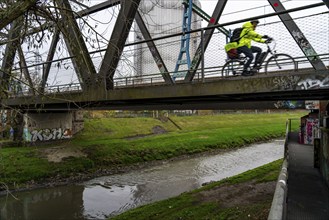 The River Emscher, sewage river, old railway bridge, now a footpath and cycle path, bridge for