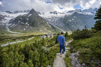 Mountaineer barefoot on a hiking trail, mountain hut Berliner Hütte, mountain peak Steinmandl,