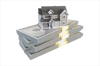 Miniature house resting on stack of thousands of dollars cash isolated on a white background