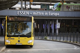 Essener Verkehrsbetriebe bus at the main railway station with local train, public transport,