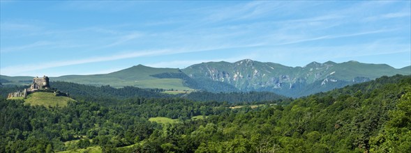 View of the medieval castle of Murol and the Sancy massif in the Auvergne Volcanoes Regional