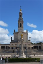 Large basilica with bell tower and statue in the foreground under a blue sky, Basilica of Our Lady