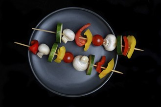 Colourful vegetable skewers on a plate, barbecue skewers