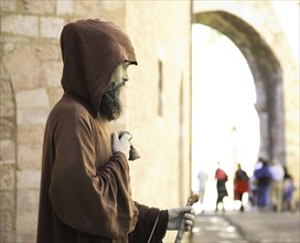 Street performer, juggler in disguise of a Franciscan monk, Assisi, Umbria, Italy (for editorial