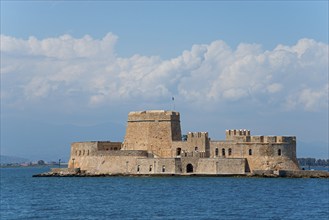 Old castle on a small island in the blue sea under a cloudy sky, fortress, Bourtz island, Bourtsi,