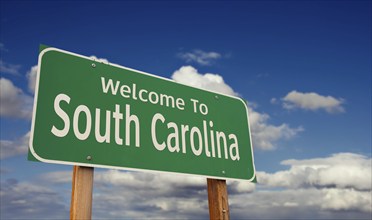 Welcome to south carolina green road sign over blue sky with some clouds