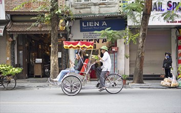 Vietnamese rickshaw driver in the Old Quarter of Hanoi, Vietnam, Asia