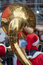 Pre-Christmas season, street musician in Father Christmas costume, Christmas market in the city