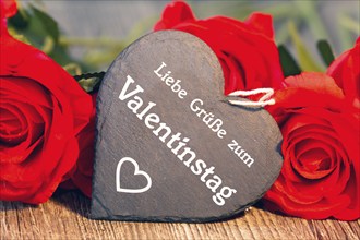 Greetings for Valentine's Day: roses and a heart with the inscription LOVE GREETINGS FOR