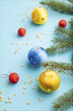 Christmas or New Year composition. Decorations, blue, red, yellow balls, fir and spruce branches,