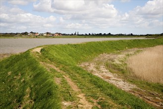 Flood defence embankment wall River Alde, Aldeburgh, Suffolk, England, United Kingdom, Europe