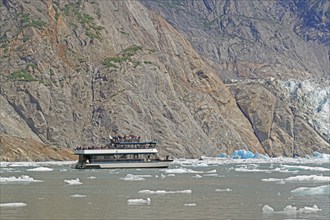 Tourist boat in Tracy Arm Fjord, icebergs and rugged Alaska, USA, North America