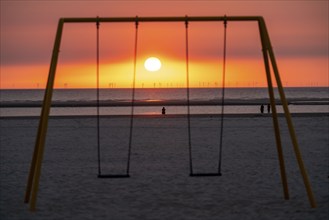 North Sea island Langeoog, early summer, beach, children's swing, offshore wind farm, sunset, Lower