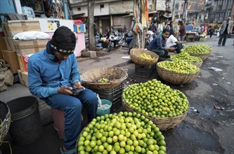 Vendor selling lemons at a market, ahead of the presentation of the Interim Budget 2024 by Union