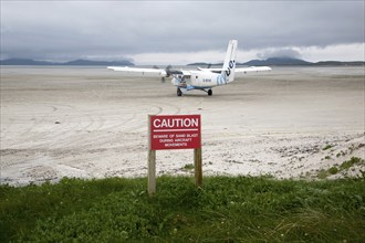 Flybe plane on sandy airstrip Isle of Barra airport, Barra, Outer Hebrides, Scotland, UK