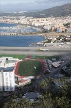 View over airport runway to Spanish town of La Linea from Gibraltar, British overseas territory in