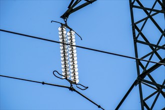 Insulators made of glass on a high-voltage line, they hang on the pylons as a suspension device