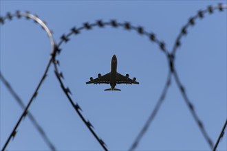 Symbolic image security, passenger aircraft taking off, security fence, Stuttgart Airport,