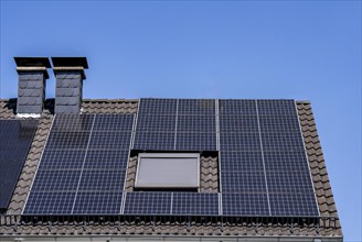 Solar system on the pitched roof of a residential building, photovoltaics for power generation, for