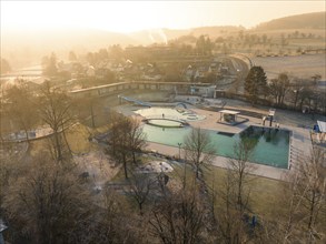 Dawn over an outdoor pool with visible fog and a rural backdrop, ENCW outdoor pool Calw, Stammheim,