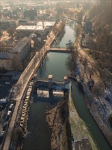 Sunny river bank with bridge and neighbouring buildings, aerial view, Nagold, Black Forest,