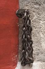 Heavy, iron chain with lock on a house wall, Regensburg, Upper Palatinate, Bavaria, Germany, Europe