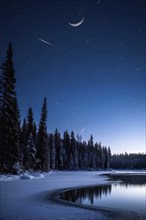 Tranquil winter night scene with a crescent moon and stars shining brightly over a frozen lake,