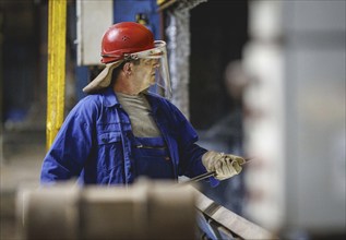 A worker stands at a boiler during a galvanising process. Taken during a press event at The Coatinc