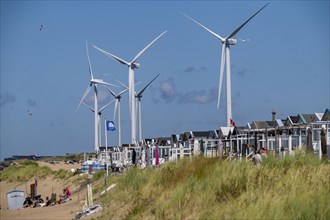 Wind turbines, wind farm, holiday homes, beach houses on the beach of Ijmuiden in North Holland,