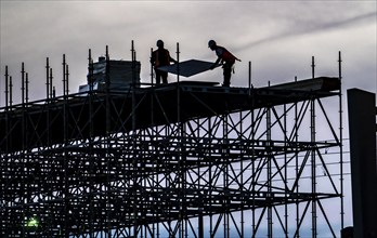 Workers dismantle scaffolding on the Erasmus Bridge over the Nieuwe Maas in Rotterdam, Netherlands