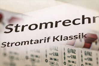 Symbolic image of electricity costs: Close-up of an electricity bill in front of a distribution box