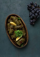 Dolma (Tolma) stuffed rolls, minced meat with rice, in grape leaves, top view, no people, close-up