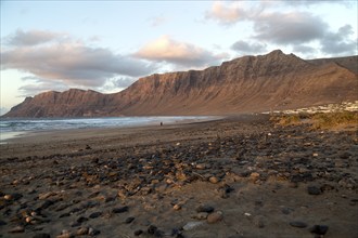 Evening sunset light on beach and cliffs La Caleta de Famara, Lanzarote, Canary islands, Spain,