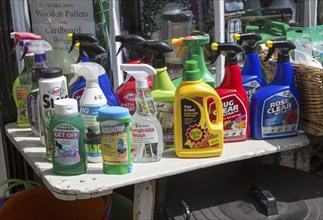 Display of various garden products in plastic spray containers outside hardware store, Woodbridge,