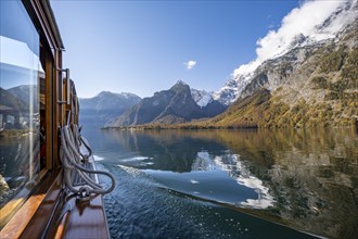 Tourist boat on the Königssee, Watzmann massif, autumnal mountain landscape reflected in the lake,