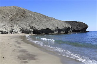 Rocky headland at Playa Monsul sandy beach, Cabo de Gata natural park, Almeria, Spain, Europe