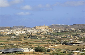 View over fields to citadel castle of Rabat Victoria, island of Gozo, Malta, Europe