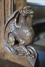 Carved wooden pew end figure, Huntingfield church, Suffolk, England, UK