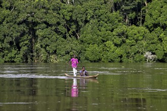 Two young men in a dugout canoe on the Sangha River, Dzanga-Sangha Complex of Protected Areas