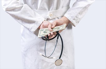 Corrupt doctor hiding money back, Dishonest doctor hiding money. Medical corruption and bribery